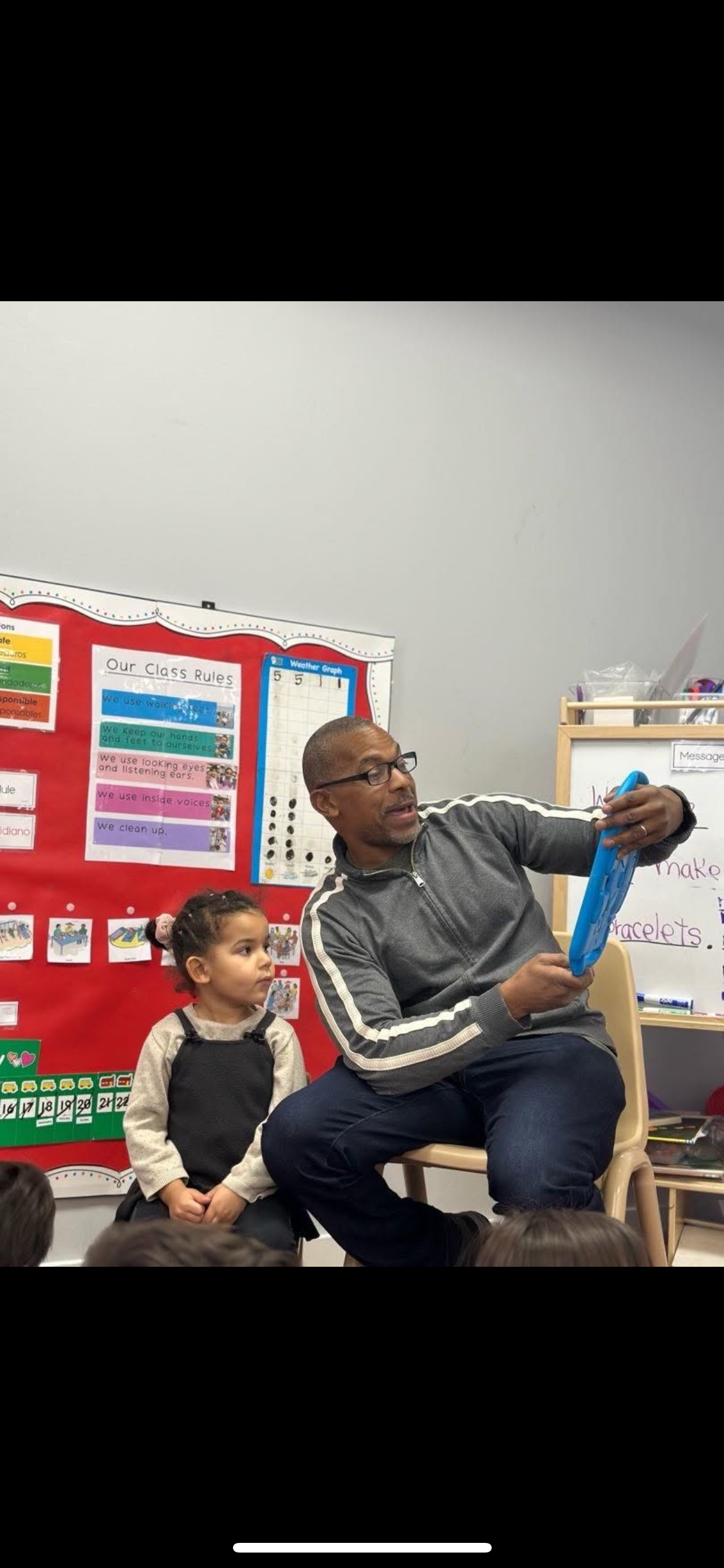 Eric Rhea reading to students in a Teaneck classroom