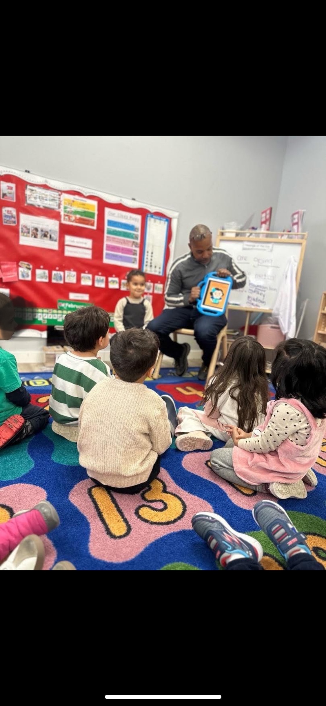 Eric Rhea engaging with students during a classroom visit