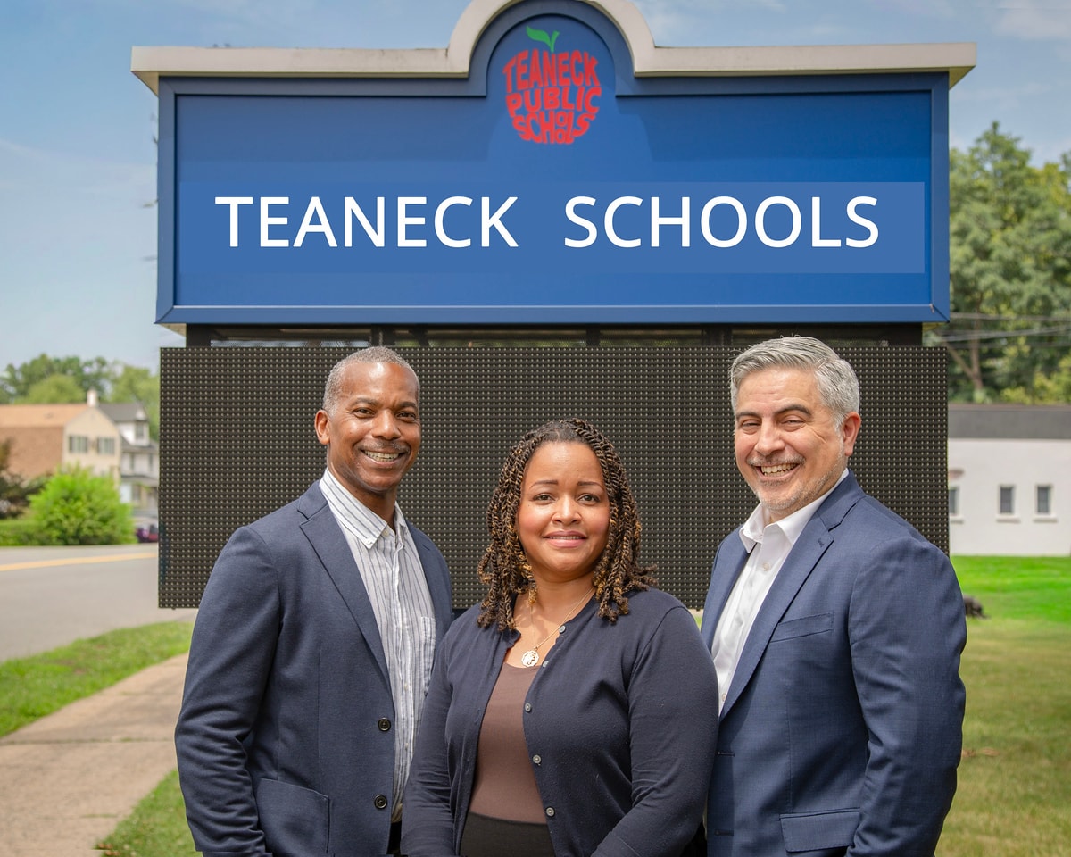 Team EFG in front of the Teaneck Public Schools sign